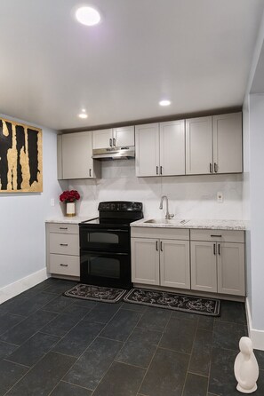 Microwave, oven, stovetop - Welcome to The Green Haven, a comfortable and modern 1-bedroom apartment. (Newark)