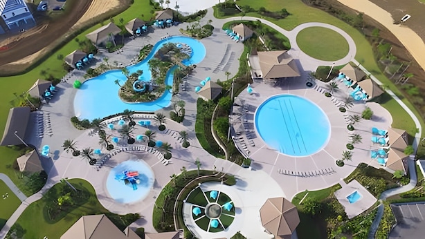 An aerial view of a resort with multiple swimming pools, lounge areas, and a central water feature. - 3BR Villa w/ Resort Access Near Disney (Davenport)