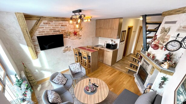 A modern apartment with a dining area, kitchen, and living room. - NPL Gorstak apartments (Jahorina)