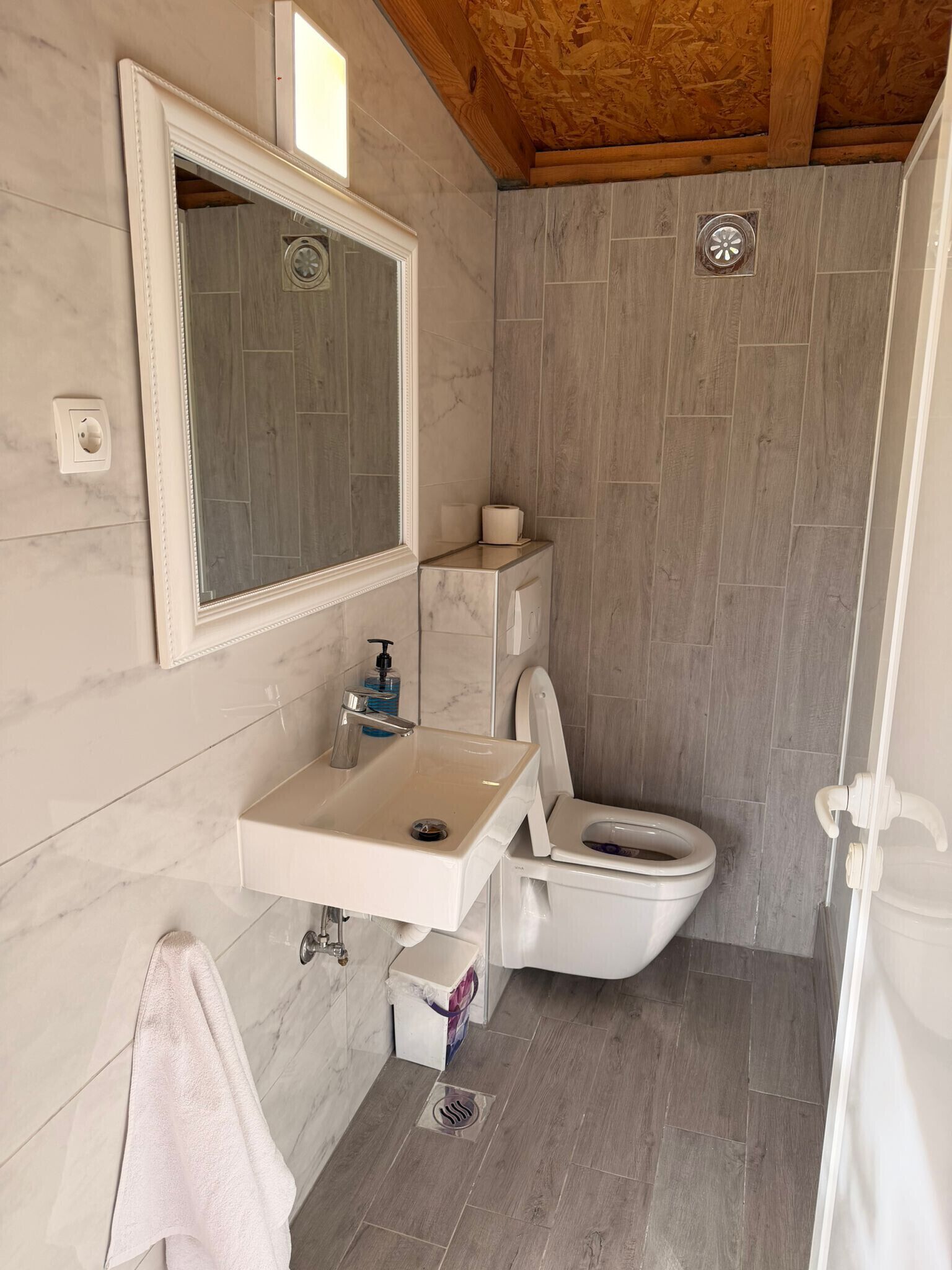 Ein Badezimmer mit Marmorwaschbecken, Toilette und Dusche.
