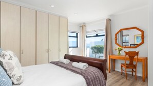 A hotel room with a large bed, a wooden desk, a chair, and a large mirror. - 19 Ascension (Cape Town)