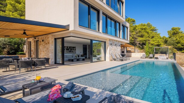A modern house with a swimming pool, outdoor furniture, and a patio area. - Incredible divine view 5-bedroom villa in Vis Town (Vis)
