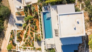 An aerial view of a modern house with a swimming pool, a covered patio, and a landscaped garden. - Incredible divine view 5-bedroom villa in Vis Town (Vis)
