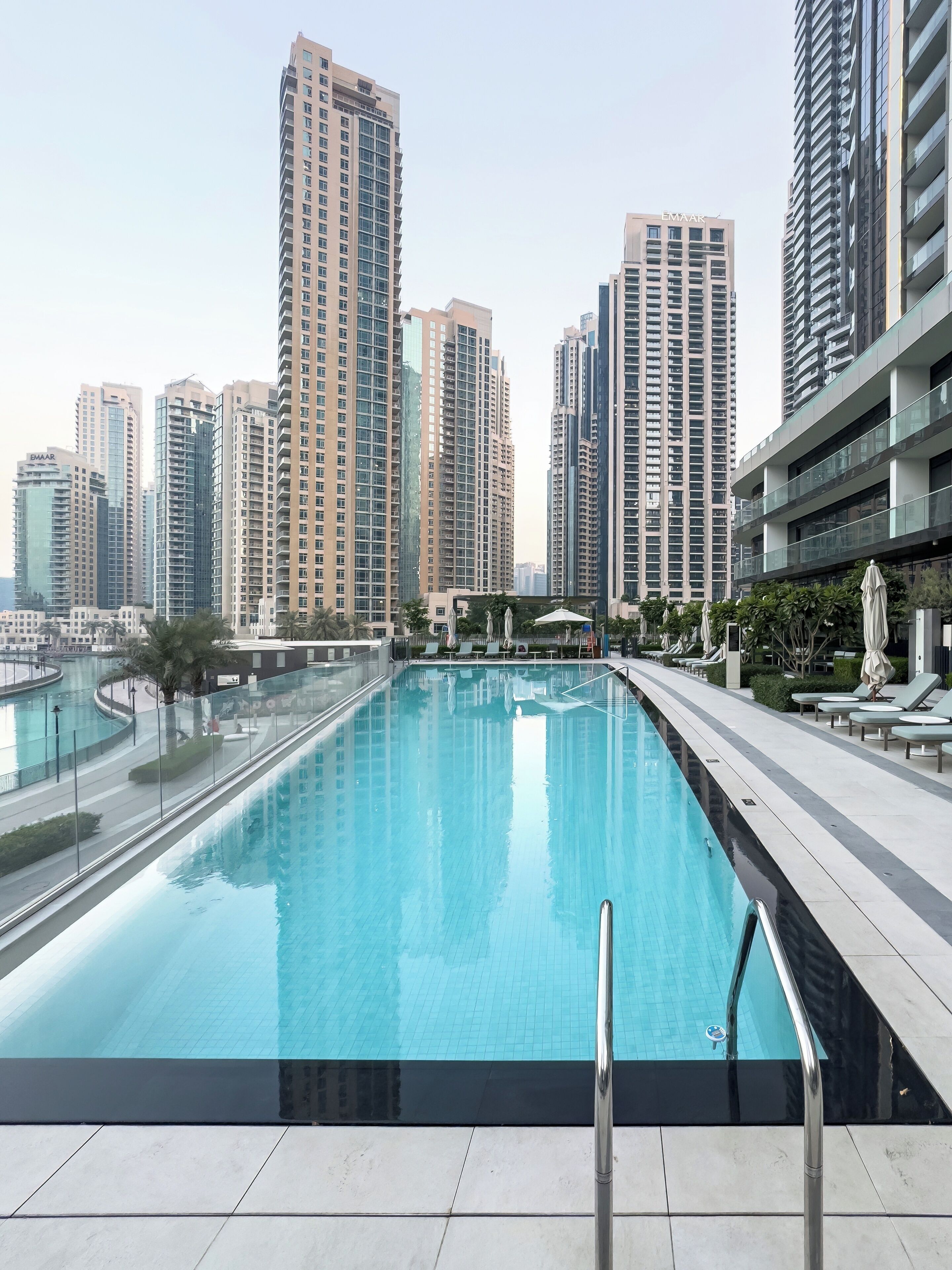 A swimming pool with a view of high-rise buildings in the background.