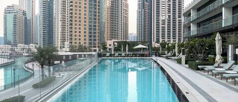 A swimming pool with a view of high-rise buildings in the background.