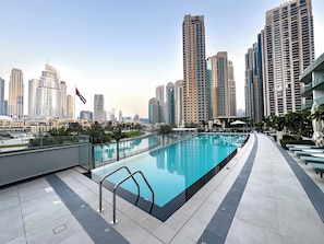 A rooftop pool with a city skyline in the background. - Skyline Seascape I Persian Gulf Views (Dubai)