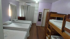 A hotel room with four single beds, a wooden bunk bed, a wooden wardrobe, an air conditioning unit, and a small window with curtains. - Casa mobiliada (Marituba)