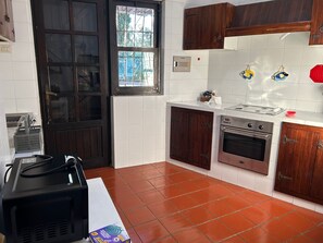 Une cuisine équipée d’une cuisinière, d’un four et de placards.