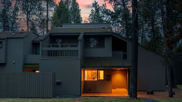 A modern two-story house with a covered front porch and a small deck. - The Meadow House in Sunriver (Sunriver)