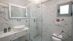 A modern bathroom with a glass-enclosed shower, a white sink, and a toilet. - Sun George (Himare)