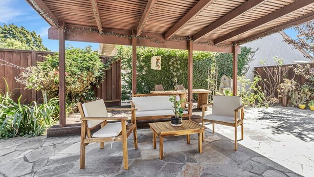 A covered patio with stone flooring, wooden furniture, and a pergola. - Tranquil 3BDR/2BA Fremont Escape (Fremont)