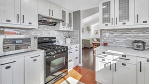 A modern kitchen with white cabinetry, a built-in oven, a microwave, and a gas stove. - 4BR3.5BA w/Epic SJ Valley Views! (San Jose)