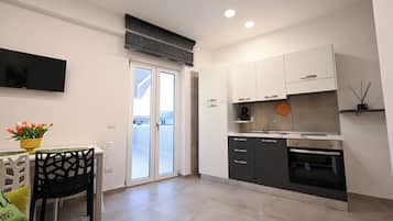 Comfort Apartment, Hot Tub (Afrodite) | Private kitchen | Full-size fridge, oven, stovetop, highchair
