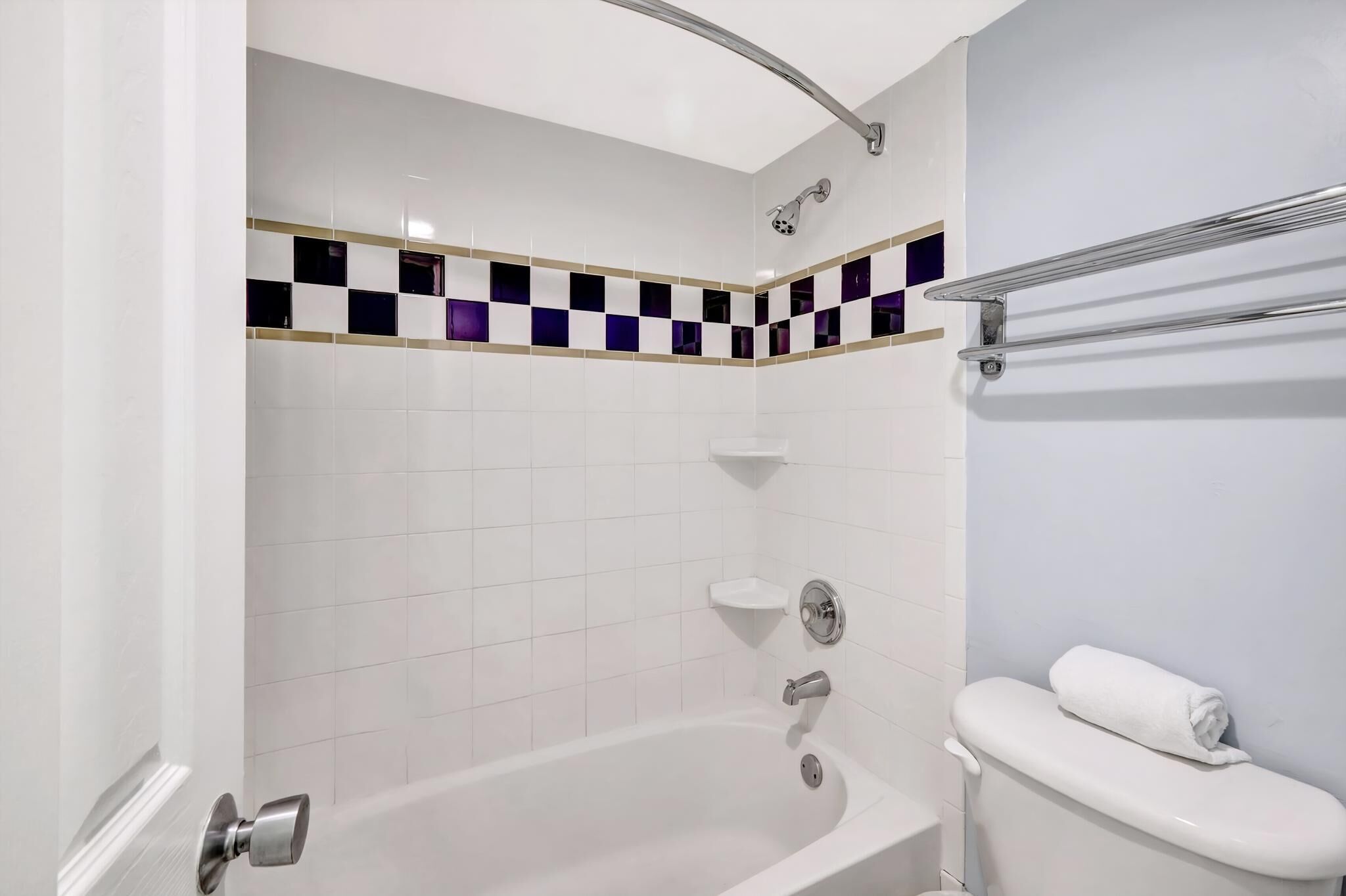A bathroom with a bathtub, a toilet, and a shower.