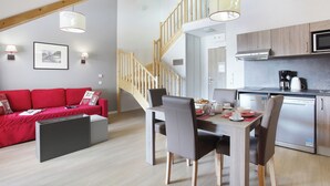 A modern kitchen with a built-in microwave, a coffee maker, and a refrigerator. - Residence Odalys Aquisana (La Salle-les-Alpes)