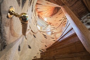 A wooden ceiling with a sloped design and a visible light fixture.