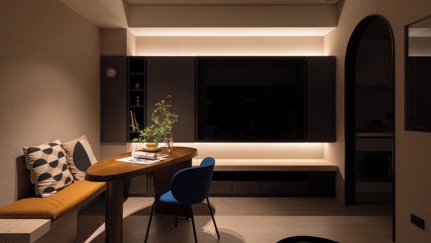 A modern dining area with a wooden table, blue chairs, a bench with patterned cushions, and a large window. - Ximen Apartment by Olala Homes (Taipei)