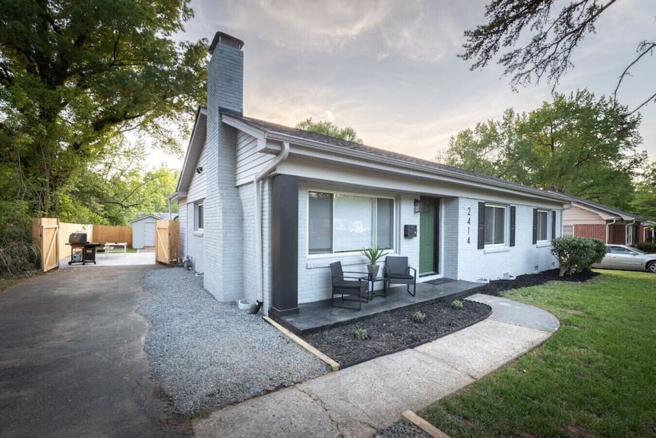A single-story house with a front porch, a small patio, and a garage.