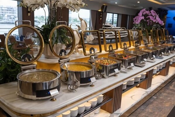 A buffet setup with multiple food stations, each with a serving tray and a bowl. - Calista Cruise - A Ha Long Bay Spectacle (Tuan Chau)