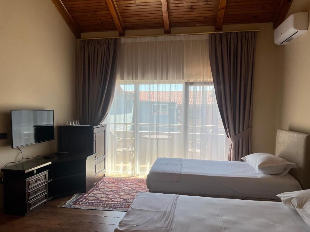 Deluxe Quadruple Room, Balcony | Hypo-allergenic bedding, minibar, desk, blackout curtains