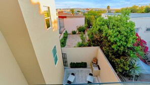 A rooftop terrace with a seating area, a small garden, and a view of the cityscape. - MarvelousStudio KingBed - 10minWalkToBorder (Tijuana)