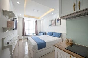 A modern hotel room with a large bed, bedside tables, a desk, and a view of the outdoors. - Cozrum Homes - Sonata Residence (Ho Chi Minh City)