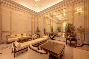A spacious room with a sofa set, a dining table, and a large mirror. - Cozrum Homes - Sonata Residence (Ho Chi Minh City)