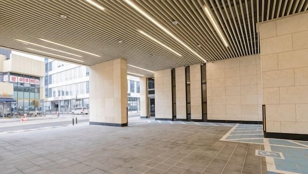 A spacious indoor area with a tiled floor, a modern ceiling design, and large windows. - Uiwang Milos Hotel (Uiwang-si)