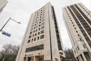 Ein hohes Gebäude mit mehreren Stockwerken und einem markanten Eingang.
