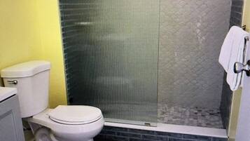 Shower, hair dryer, towels, toilet paper