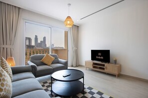 TV - Bright 2BR in JVC | Pool, Gym & Modern Comfort (Dubai)