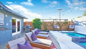 A backyard with a pool, lounge chairs, and a grill. - Eclectic Bohemian Maximalist Pad with Pool and Spa (Desert Hot Springs)
