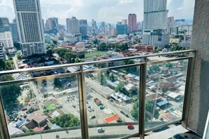 A cityscape view from a high-rise building with multiple floors and large windows. - Summer Suites KLCC by Luna (Kuala Lumpur)