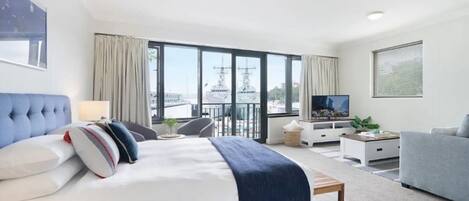 Laptop workspace, iron/ironing board, bed sheets