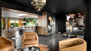 A modern interior with leather sofas, a chandelier, and a dining area with a view. - Old Town's  Luxury Oasis - 16+ Guests, Designed for entertainment & relaxation. (Scottsdale)