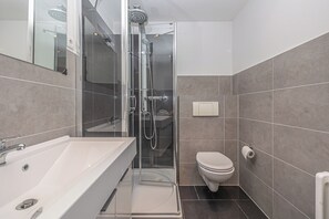 Shower, hair dryer, towels, toilet paper