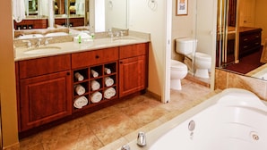 A modern bathroom with a large mirror, two sinks, a bathtub, and a walk-in shower. - Westgate Resort & Casino Las Vegas 1-bedroom (Las Vegas)