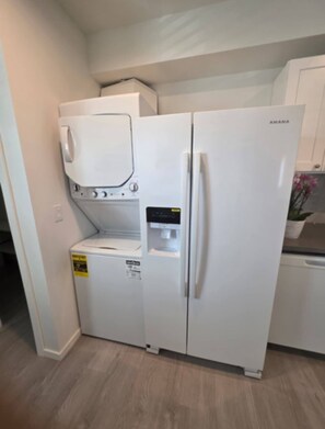 A compact kitchen with a built-in washer and dryer, a refrigerator, and a microwave. - Private Porter Ranch Gem-Parking & Near CSUN (Los Angeles)