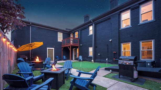 A backyard with a barbecue grill, outdoor seating, and a fire pit. - Stable #5 ~ Mini Golf, Fire Pits, Games, Walkable (Louisville)