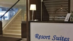 A reception desk labeled 'Resort Suites' with a staircase, a lamp, and a view of the city. - Sunway Resort Suites @ Sunway Lagoon by Landmark (Subang Jaya)