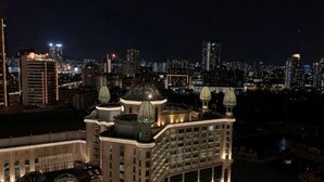A high-rise building with multiple domed structures, likely a hotel, with a cityscape in the background. - Sunway Resort Suites @ Sunway Lagoon by Landmark (Subang Jaya)