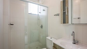 A modern bathroom with a glass-enclosed shower, a toilet, and a sink with a wooden vanity. - Apt. w/ Balcony and BBQ 250m From the sea Mrs0402 (Bombinhas)