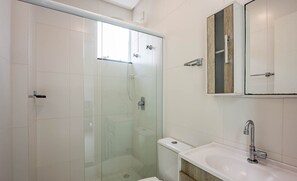 A modern bathroom with a glass-enclosed shower, a toilet, and a sink with a wooden vanity. - Apt. w/ Balcony and BBQ 250m From the sea Mrs0402 (Bombinhas)