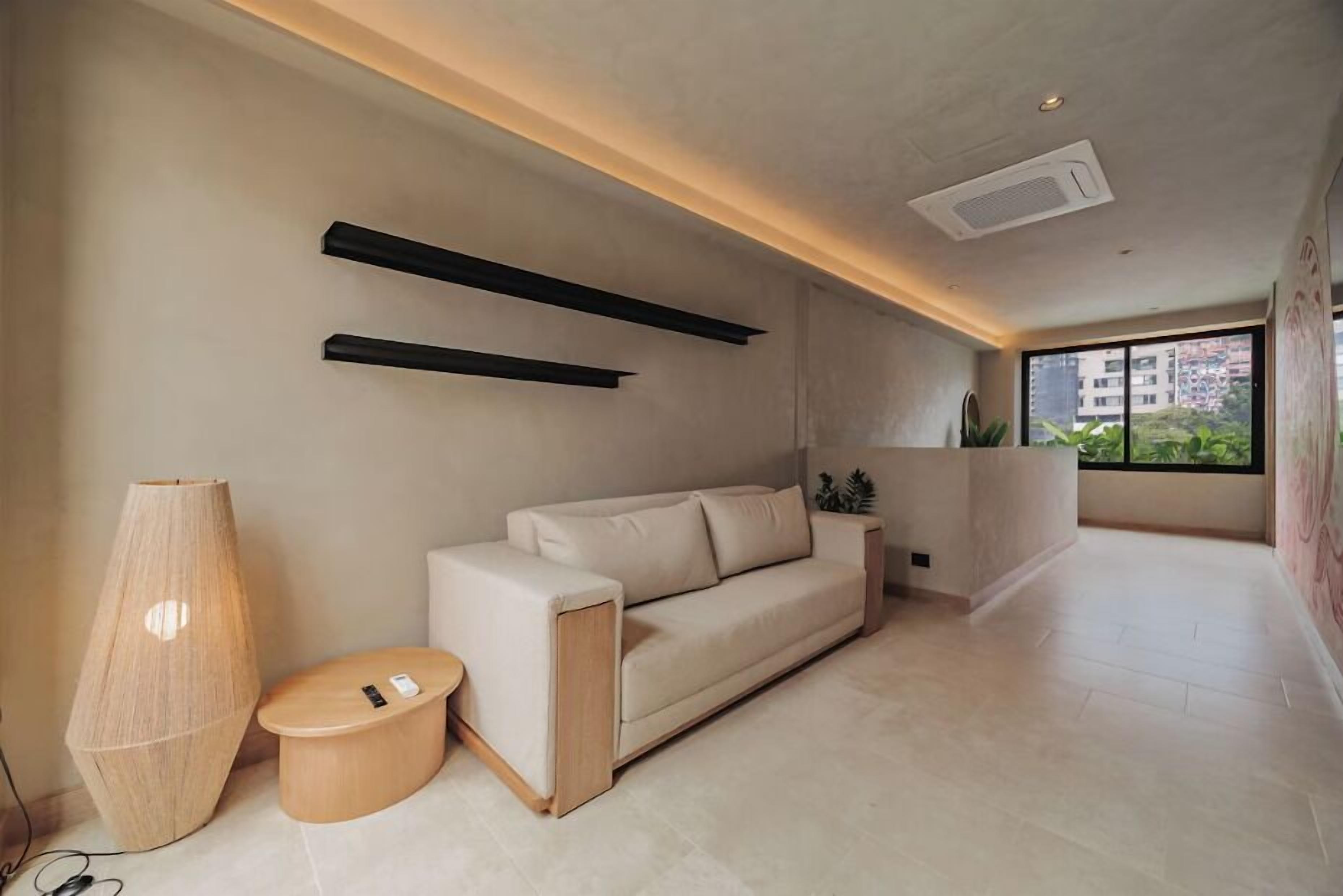 A modern living room with a sofa, a coffee table, and a floor lamp.