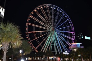 A large Ferris wheel with colorful lights at night. - 1 BR at Beach Cove Resort,Pools, Direct Oceanfront (North Myrtle Beach)
