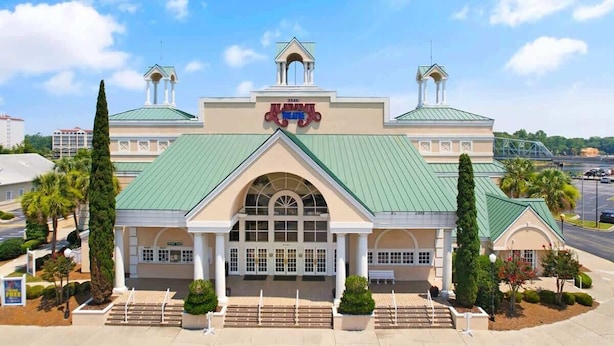 A theater with a green roof and a central entrance. - Large 3BR Private Condo - Magnolia Pointe - Pools (Myrtle Beach)