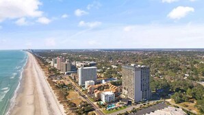 A coastal hotel with multiple high-rise buildings, a beach, and a parking area. - 1BR Oceanview Condo, Ocean Forest Plaza,High Floor (Myrtle Beach)