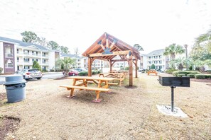 A covered picnic area with benches, a trash can, and a mailbox. - NEW Large 2BR- Pools - River Oaks Golf - Hot Tubs (Myrtle Beach)