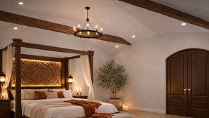 A bedroom with a four-poster bed, a chandelier, a large wooden wardrobe, and a potted plant. - Private and Unique 14 acre European Lakefront Villa in Texas! (Hubbard)