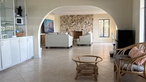A spacious living area with a kitchen, a fireplace, and a dining area.